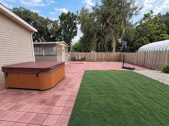 1722 Evergreen St, Kissimmee FL: patio and paved parking area in the back